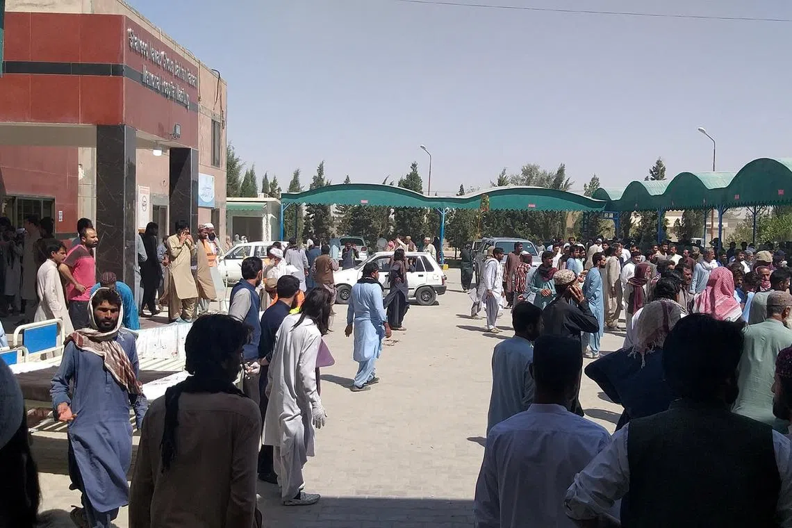 People gather outside the Mastung hospital following the deadly suicide attack in Balochistan province, Pakistan.