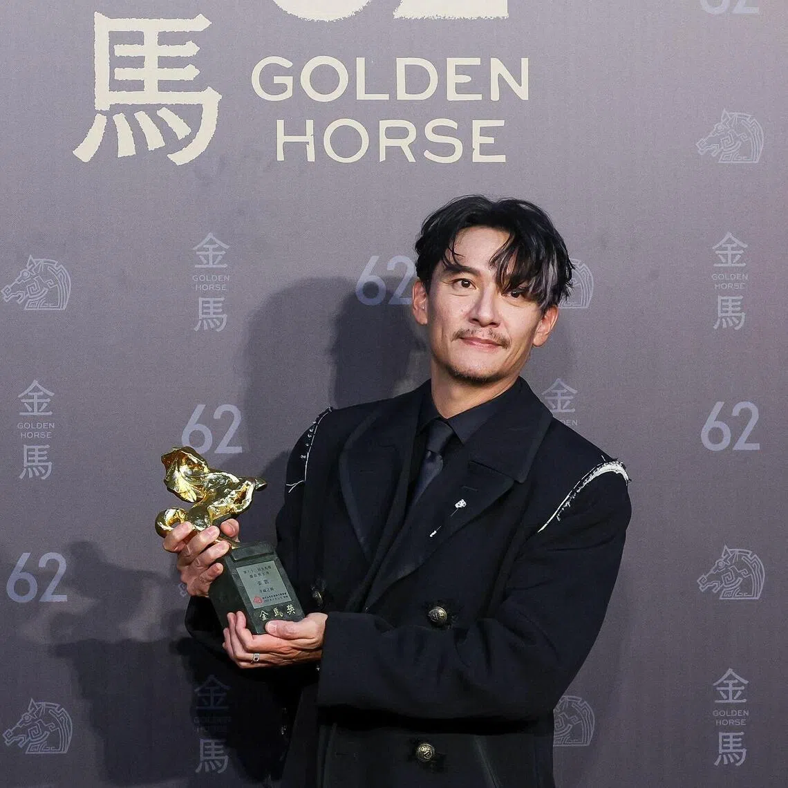 Taiwanese actor Chang Chen poses after winning best leading actor for the movie Lucky Lu.