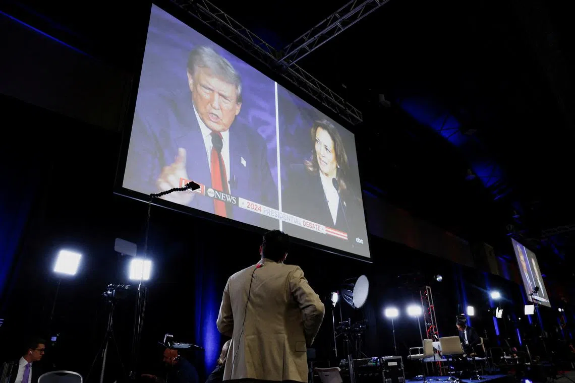 FILE PHOTO: A screen displays the presidential debate hosted by ABC between Republican presidential nominee, former U.S. President Donald Trump and Democratic presidential nominee, U.S. Vice President Kamala Harris in Philadelphia, Pennsylvania, U.S., September 10, 2024. REUTERS/Evelyn Hockstein/File Photo