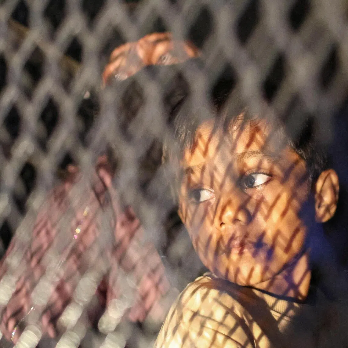 Rohingya refugees sitting inside a truck as they are taken by police, in front of the office of the UN refugee agency, after being evicted from their homes, in Kuala Lumpur, Malaysia, on July 27, 2026.
