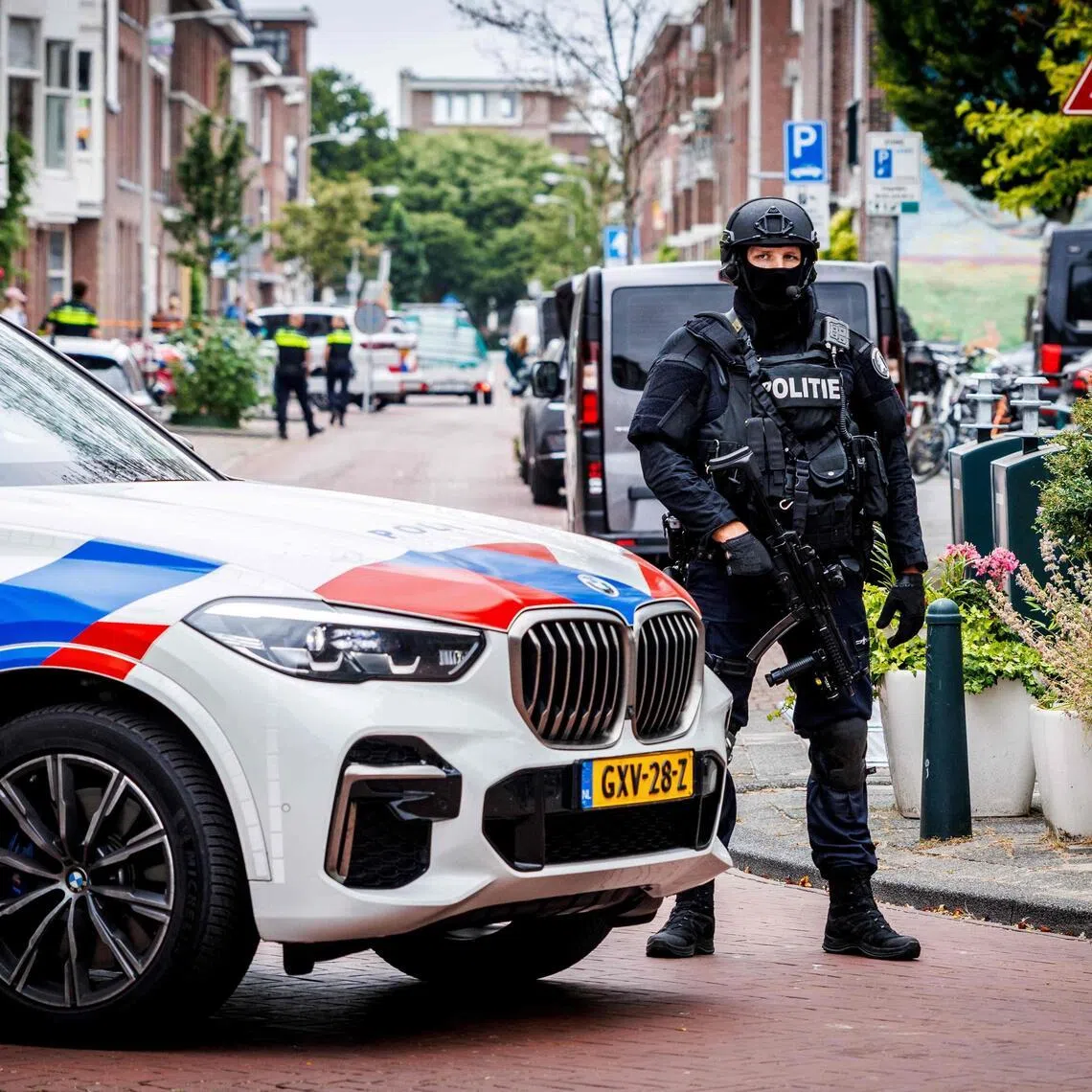 A Dutch police officer standing guard after a clandestine drug laboratory was discovered in a house on Meidoornstraat, in The Hague, on July 18.