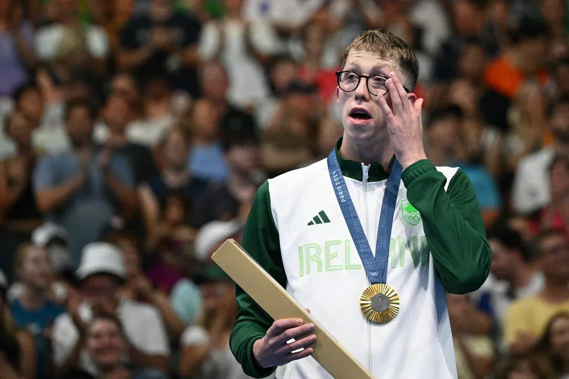 Ireland's Daniel Wiffen poses with his gold medal on the podium of the men's 800m freestyle swimming event during the Paris 2024 Olympic Games.