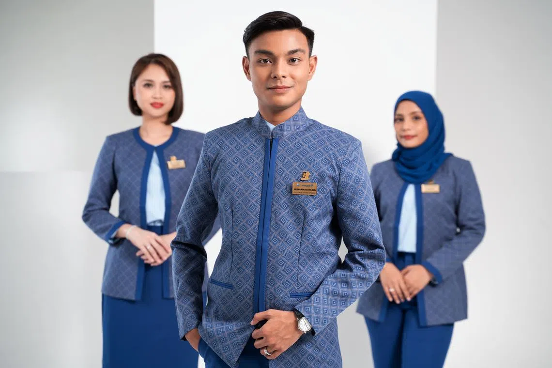 The new uniform includes a tailored navy-blue three-piece suit, with skirt or trouser options for women.