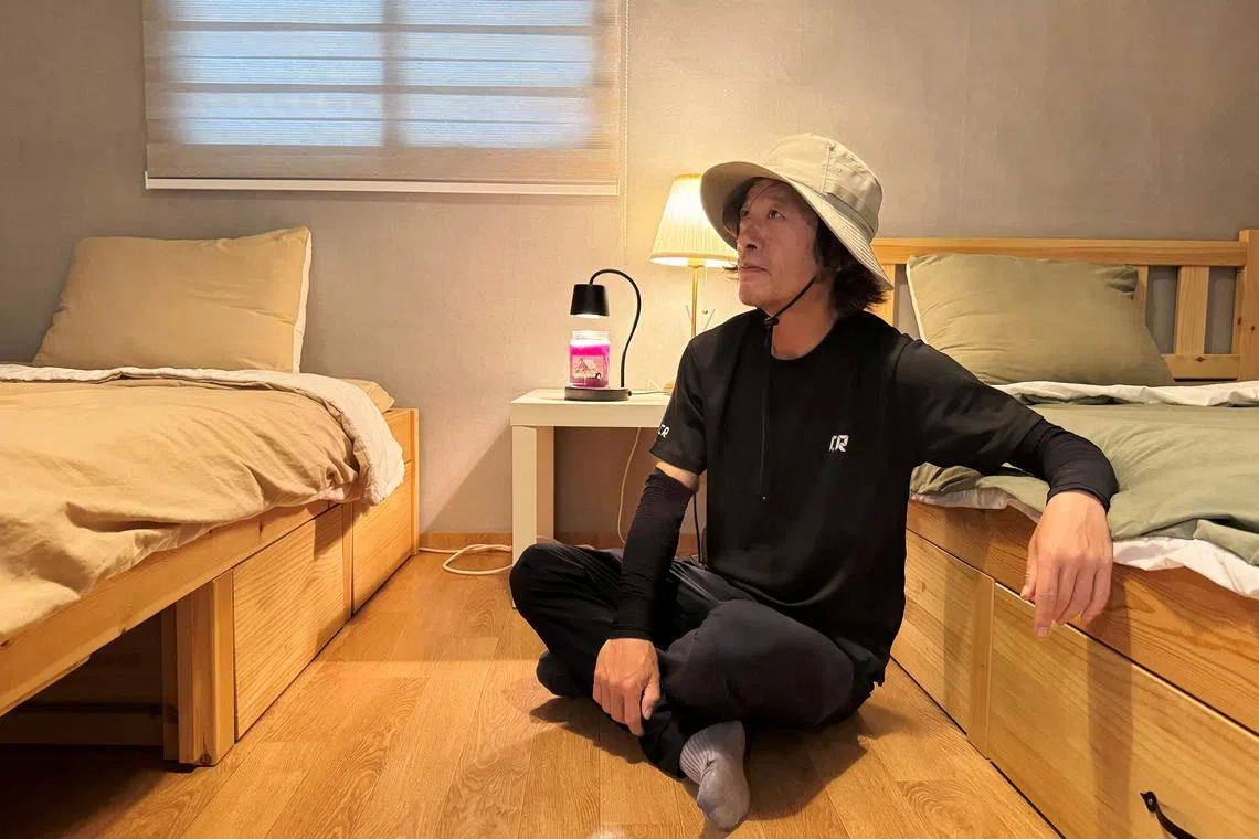 Yoon Seol-hyun, who runs a guesthouse near the demilitarized zone separating the two Koreas, rests before an interview with Reuters in Paju, South Korea, June 5, 2024. REUTERS/Hyunyoung Yi