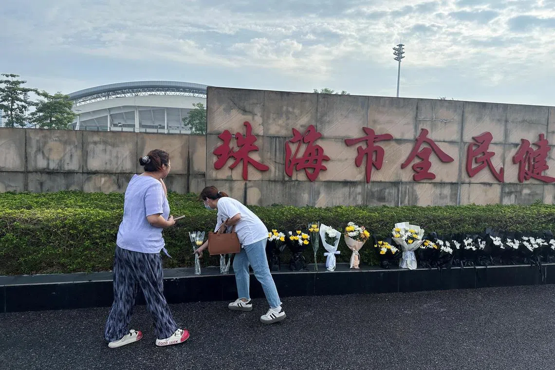 People place floral tributes outside a sports centre where a deadly car attack took place, in Zhuhai, Guangdong province, China November 13, 2024. REUTERS/Tingshu Wang      TPX IMAGES OF THE DAY     