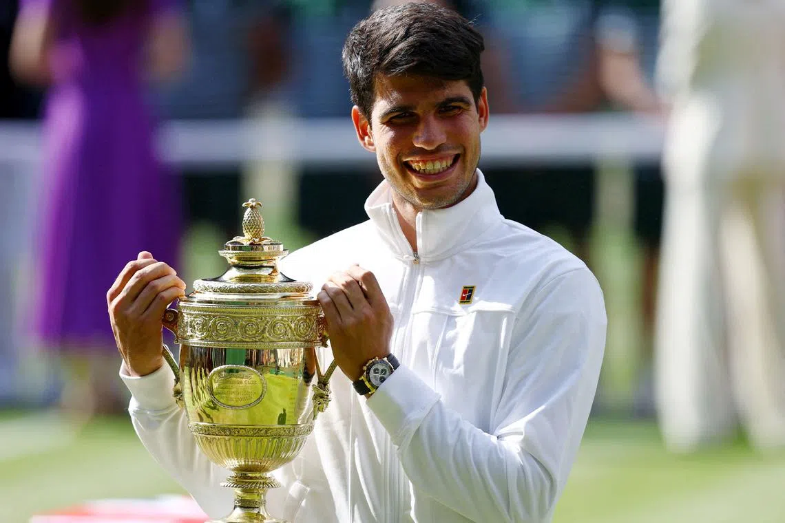 FILE PHOTO: Tennis - Wimbledon - All England Lawn Tennis and Croquet Club, London, Britain - July 14, 2024 Spain's Carlos Alcaraz poses for a picture with the trophy after winning his men's singles final against Serbia's Novak Djokovic REUTERS/Hannah Mckay/File Photo