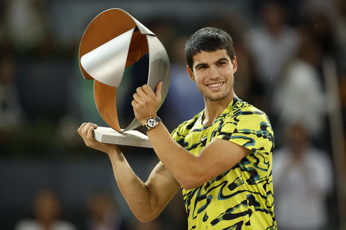 Spain's Carlos Alcaraz celebrates with the trophy after winning his final match against Germany's Jan-Lennard Struff.