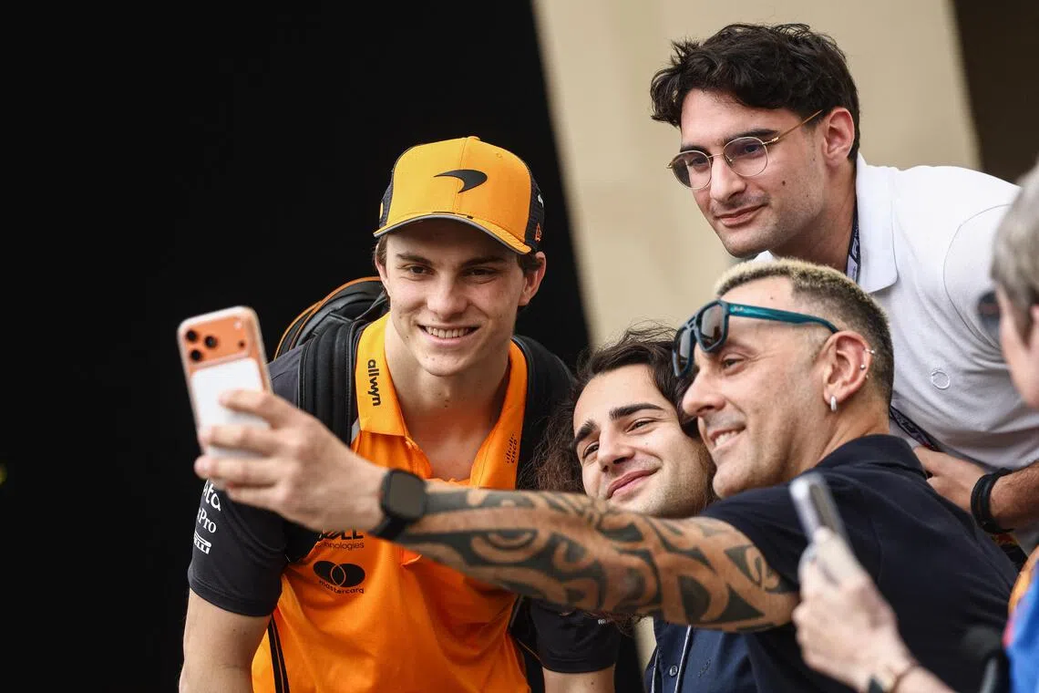 McLaren’s Oscar Piastri posing for a wefie  with fans ahead of the Abu Dhabi GP.