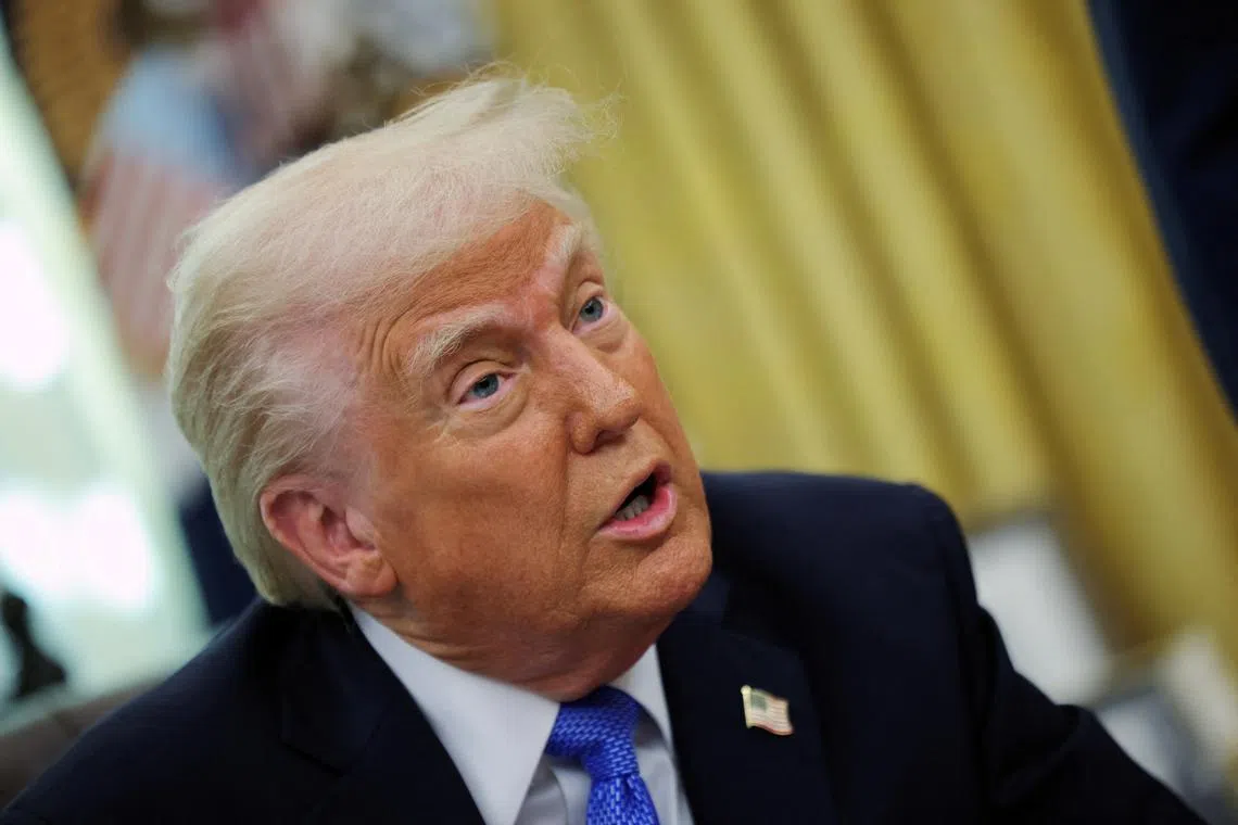 FILE PHOTO: U.S. President Donald Trump delivers remarks in the Oval Office at the White House, in Washington, D.C., U.S., March 21, 2025. REUTERS/Carlos Barria/File Photo