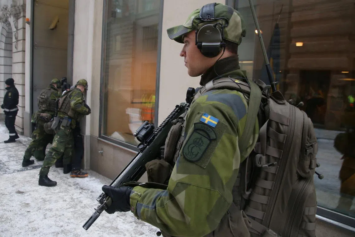FILE PHOTO: A Swedish solider takes part in an exercise in central Stockholm, Sweden, February 17, 2025. REUTERS/ Tom Little/File Photo