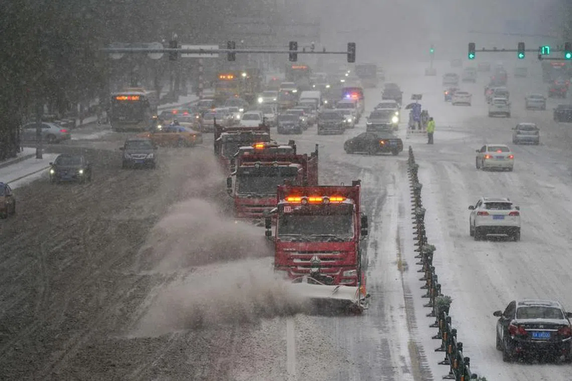 Snow removal vehicles move on a street amid a blizzard in Harbin, Heilongjiang province, China November 6, 2023. cnsphoto via REUTERS