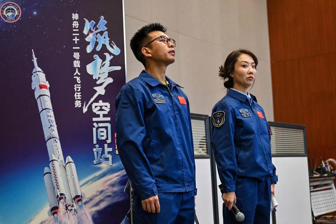 China's space agency staff at a press conference for the Shenzhou-21 Manned Space Mission one day before the mission's launch.f