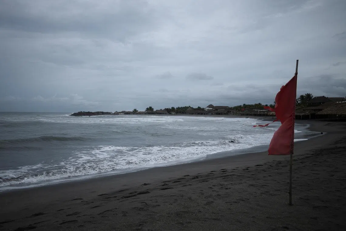 A red flag flutters in the wind, warning beachgoers of dangerous conditions as Tropical Storm Erick strengthens off Mexico's Pacific Coast, in San Benito, Chiapas state, Mexico, June 17, 2025. REUTERS/Damian Sanchez