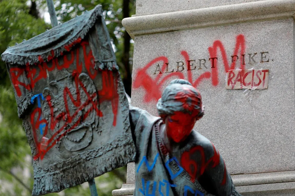 FILE PHOTO: Messages of protest remain after protesters toppled the statue of Albert Pike, amid a series of racial inequality protests, at the Brigadier General Albert Pike Statue site near Capitol Hill in Washington, U.S., July 7, 2020. REUTERS/Tom Brenner/File Photo