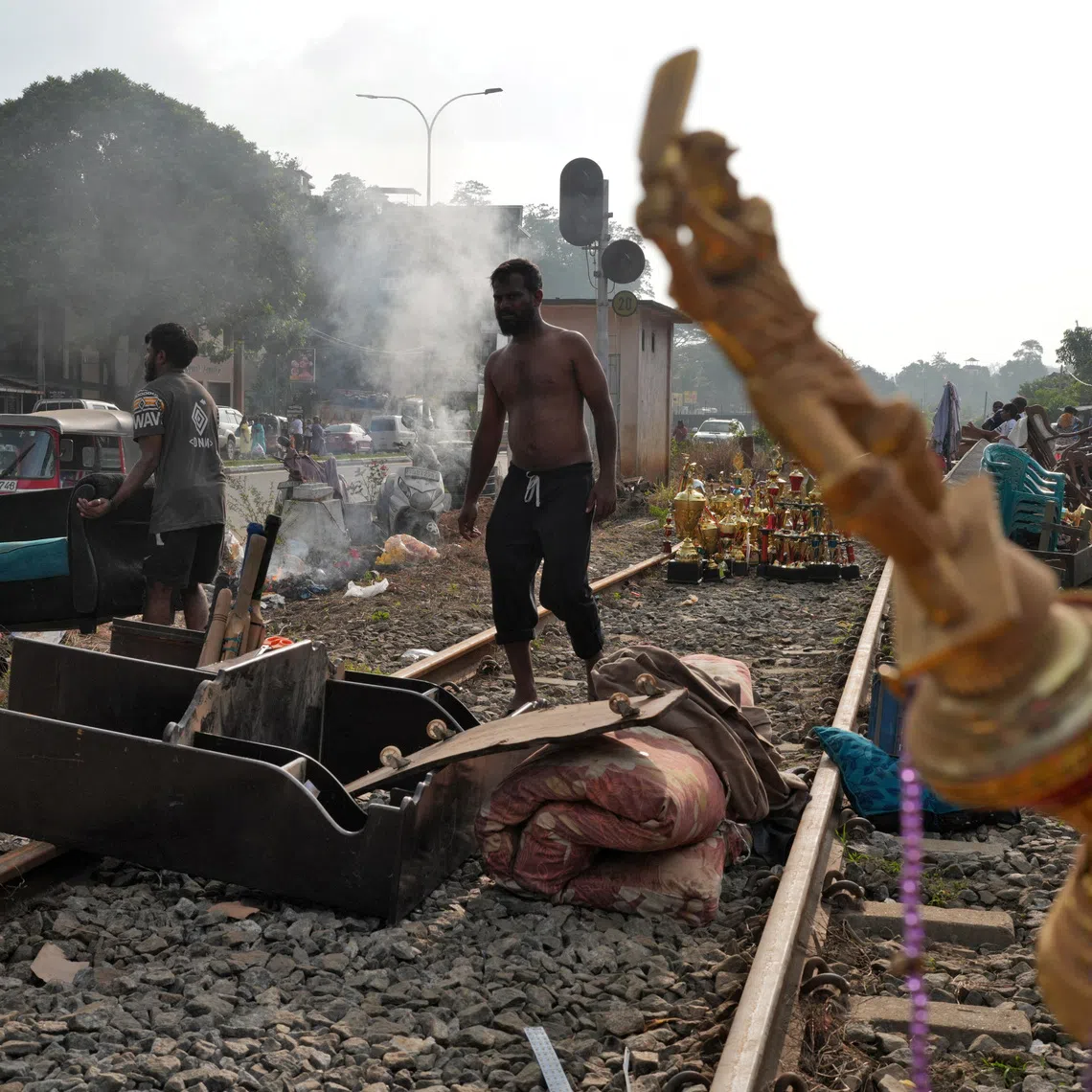People affected by floods collect their belongings from the railway tracks after drying them following Cyclone Ditwah Kandy, Sri Lanka, December 3, 2025. REUTERS/Thilina Kaluthotage