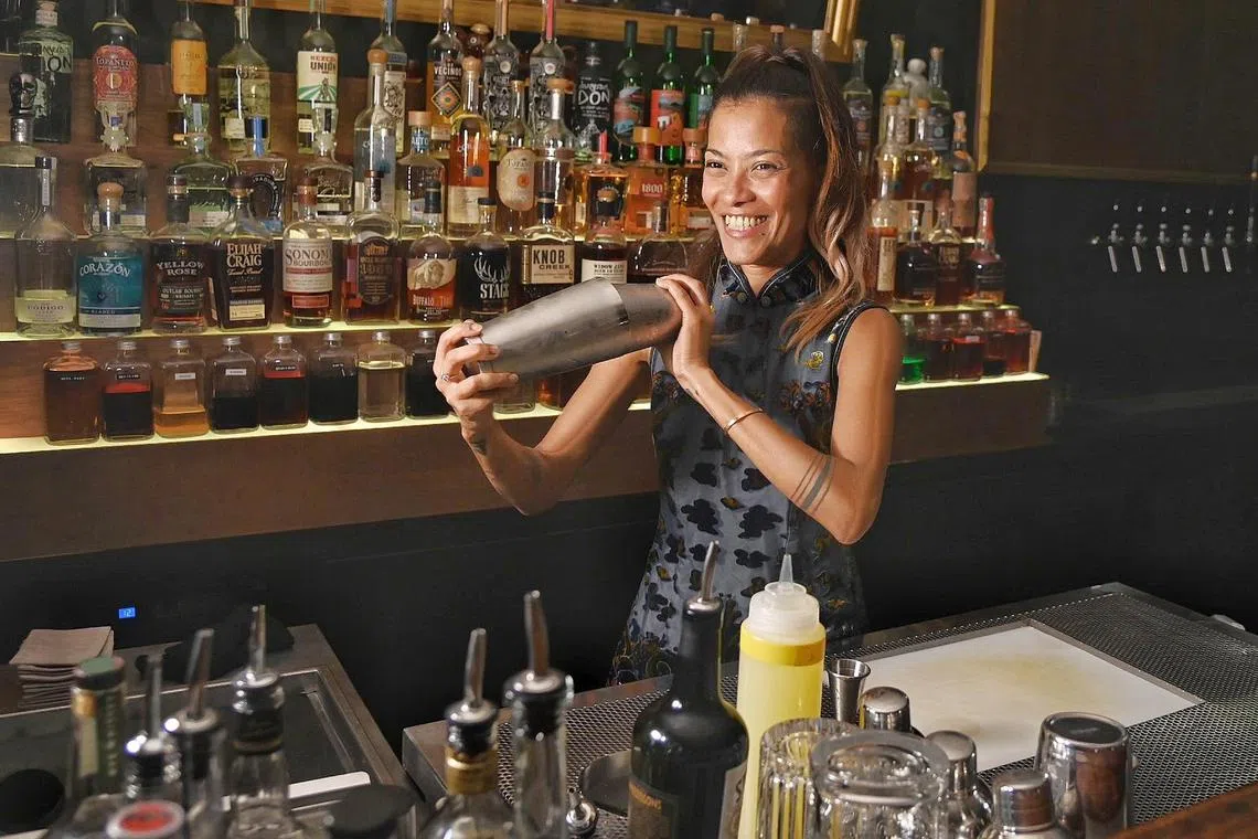 Ms Desiree Jane Silva shaking up a cocktail at Underdog Inn in Amoy Street on May 3, 2023. 