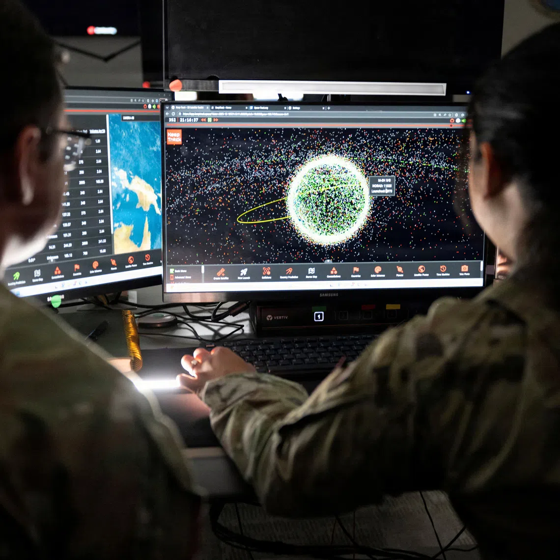 U.S. Space Force Guardians assigned to Space Delta 5 monitor computer workstations at Vandenberg Space Force Base, California, U.S., December 18, 2025.  U.S. Space Forces/David Dozoretz/Handout via REUTERS