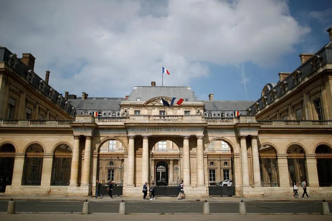 FILE PHOTO: People walk past the Conseil d'Etat, France's highest administrative court, in Paris, France, August 16, 2021. REUTERS/Sarah Meyssonnier/File Photo
