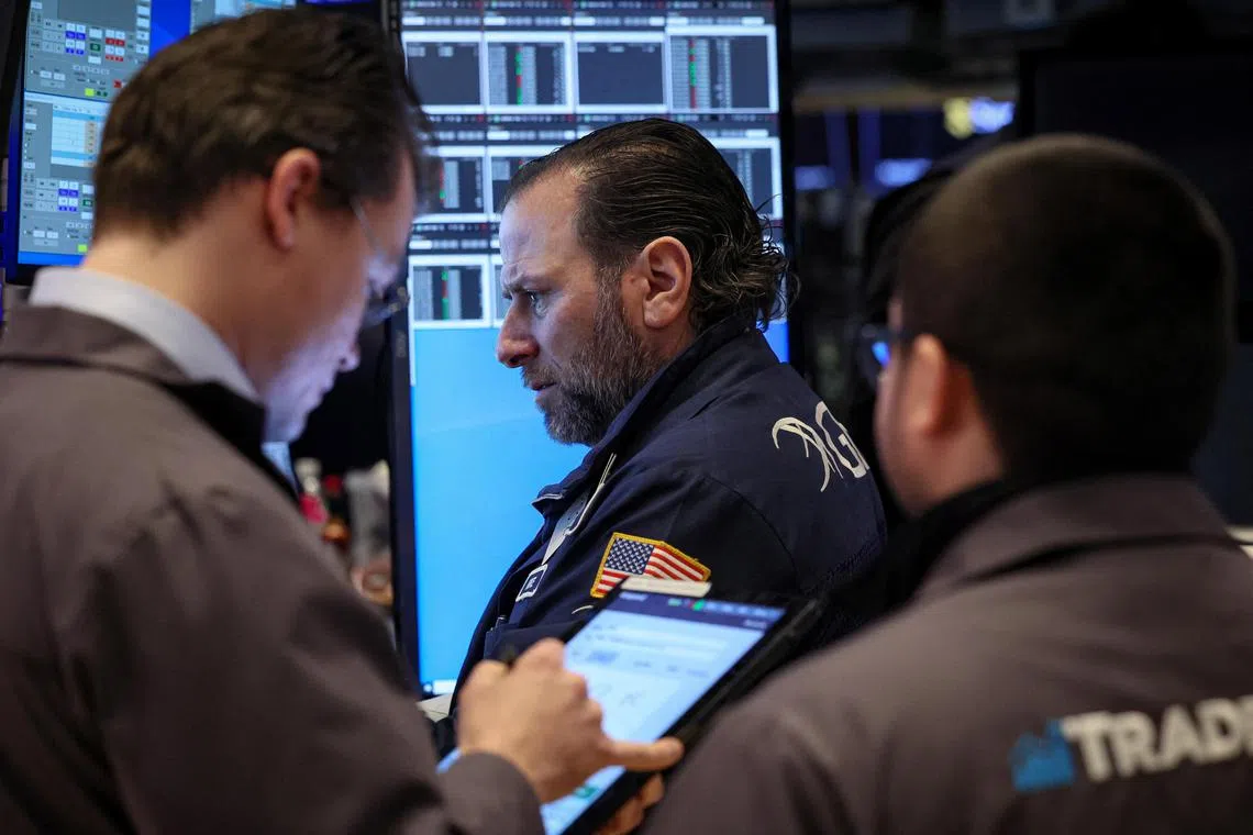 Traders work on the floor at the New York Stock Exchange, in New York City.