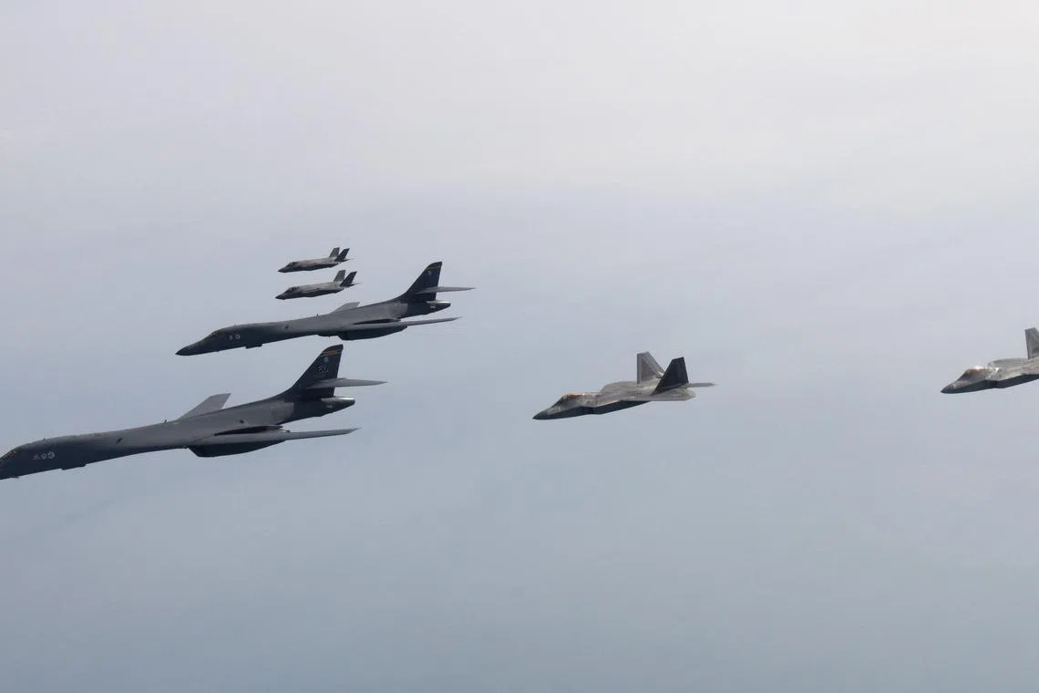 This handout photo taken on February 1, 2023 and provided by the South Korean Defence Ministry in Seoul shows two US Air Force B-1B strategic bombers (L), South Korean Air Force F-35 fighter jets (top) and US Air Force F-22 stealth fighter jets (R) flying over the Yellow Sea, located between China and the Korean peninsula, during a joint air drill. - South Korea and the United States staged joint air drills featuring an American strategic bomber and stealth fighter planes in response to threats from North Korea drawing an angry rebuke from Pyongyang. (Photo by Handout / South Korean Defence Ministry / AFP) / RESTRICTED TO EDITORIAL USE - MANDATORY CREDIT "AFP PHOTO / South Korean Defence Ministry" - NO MARKETING NO ADVERTISING CAMPAIGNS - DISTRIBUTED AS A SERVICE TO CLIENTS
