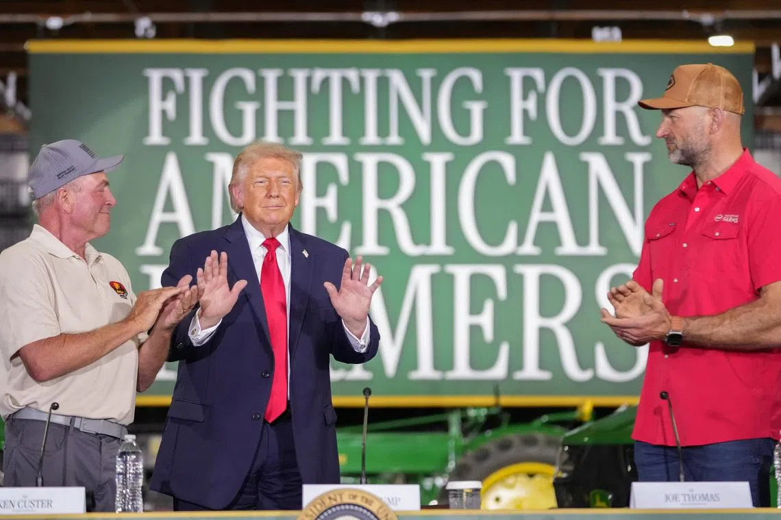U.S. President Donald Trump stands next to Ken Custer and Joe Thomas during an event at Custer Farms in Chippewa Falls, Wisconsin, U.S., June, 5, 2026. REUTERS/Nathan Howard