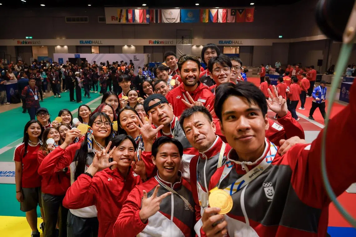Singapore fencer Simon Lee Renjie (front) and the fencing team taking a group picture after the end of the medal ceremony at Fashion Island Shopping Mall during the Thailand SEA Games in Bangkok on Dec 19, 2025.