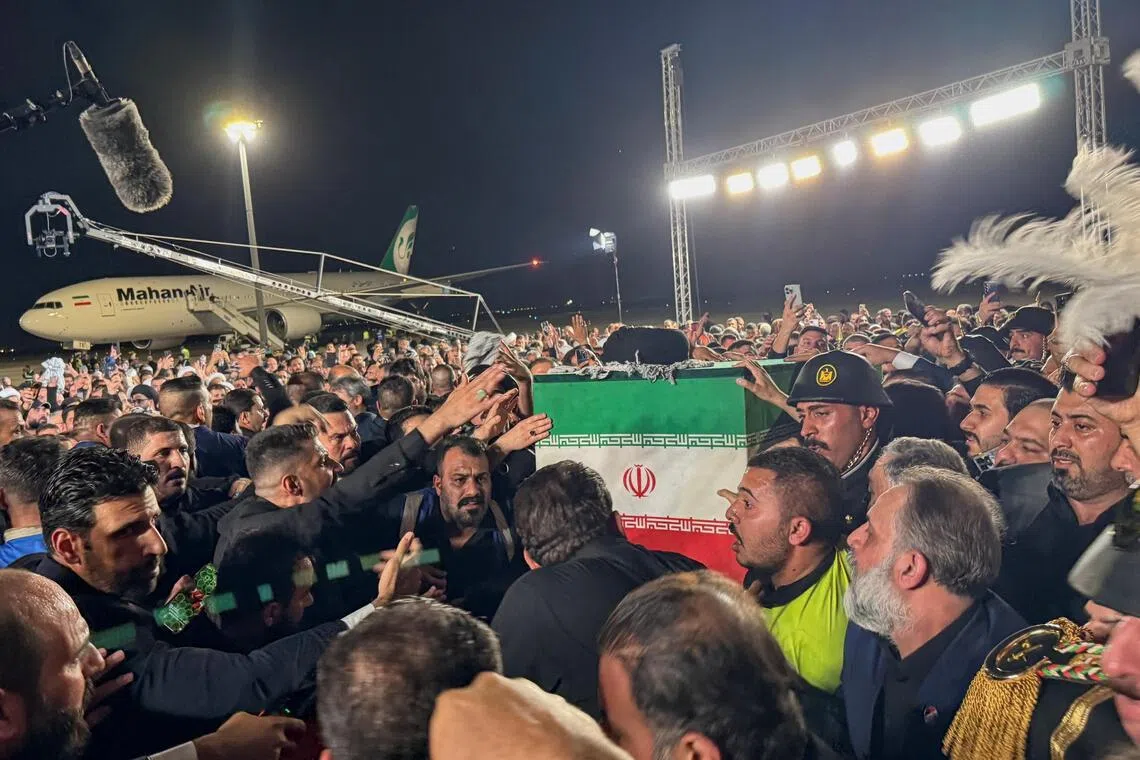 The coffin of Iran’s late Supreme Leader Ayatollah Ali Khamenei, who was killed on February 28 during Israeli and U.S. airstrikes on Iran, is carried after arriving aboard a Mahan Air aircraft at Najaf International Airport in Najaf, Iraq, July 7, 2026. Picture taken with a mobile phone. REUTERS/Stringer