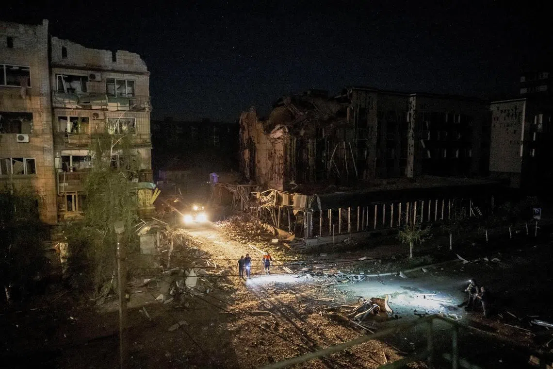 Rescuers working at a site of a building destroyed during a Russian missile strike, amid Russia's attack on Ukraine, in Pokrovsk, Ukraine on Tuesday.  