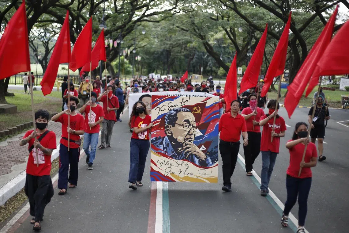 Supporters marching to pay respects to the late Philippine communist leader Jose Maria Sison in Quezon, the Philippines, on Dec 19.