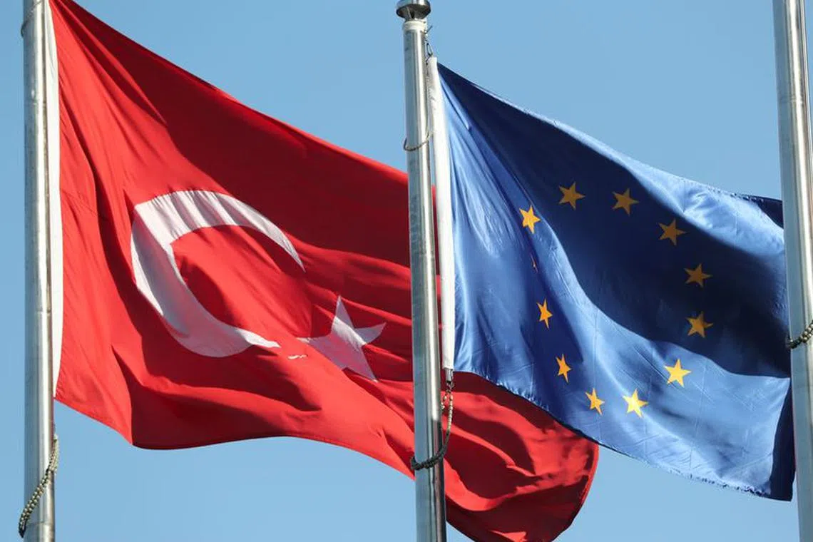 FILE PHOTO: European Union (R) and Turkish flags fly at the business and financial district of Levent in Istanbul, Turkey September 4, 2017. REUTERS/Osman Orsal/File Photo