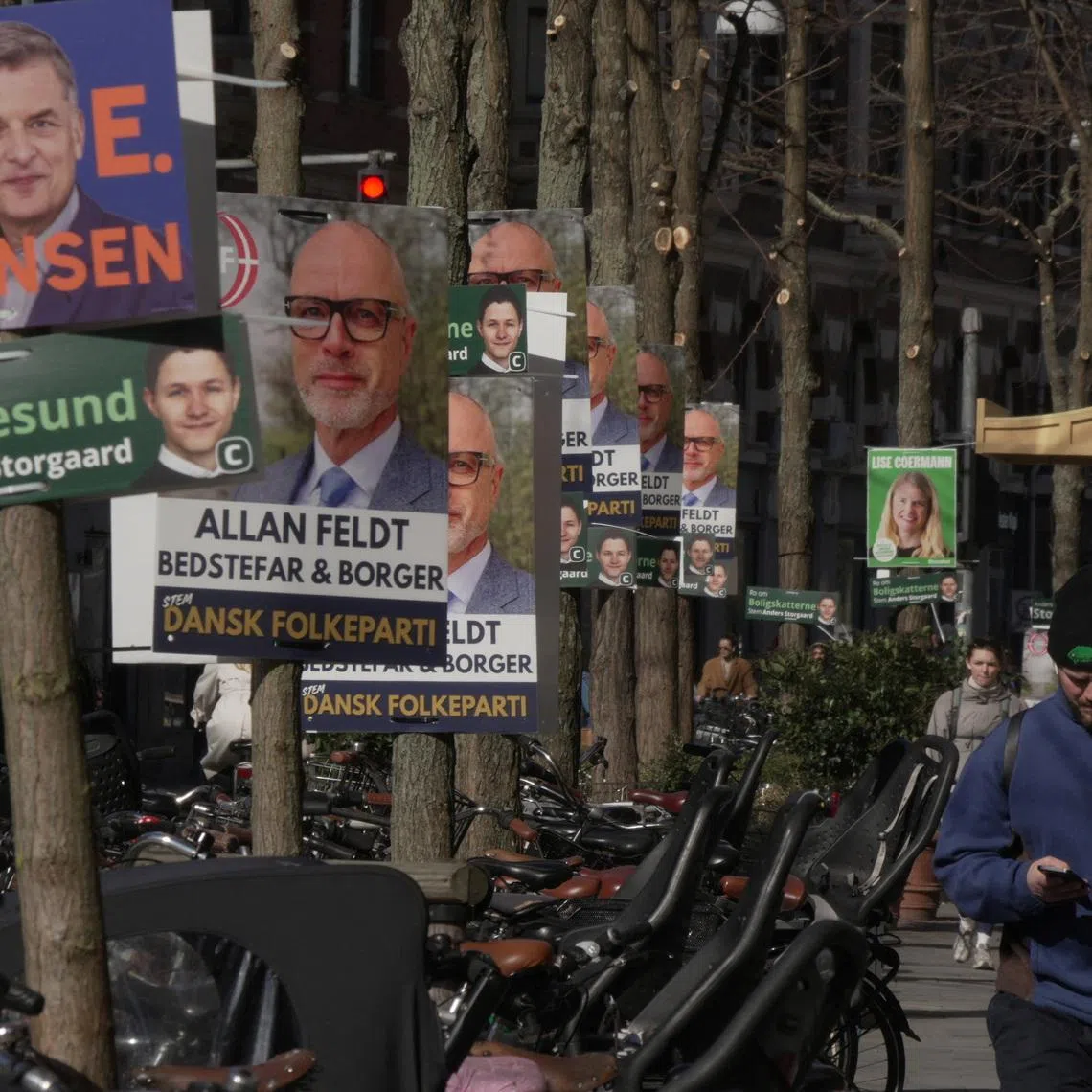 A pedestrian walks past posters for candidates in the upcoming Danish elections, in Copenhagen, Denmark, March 18, 2026. REUTERS/Tom Little