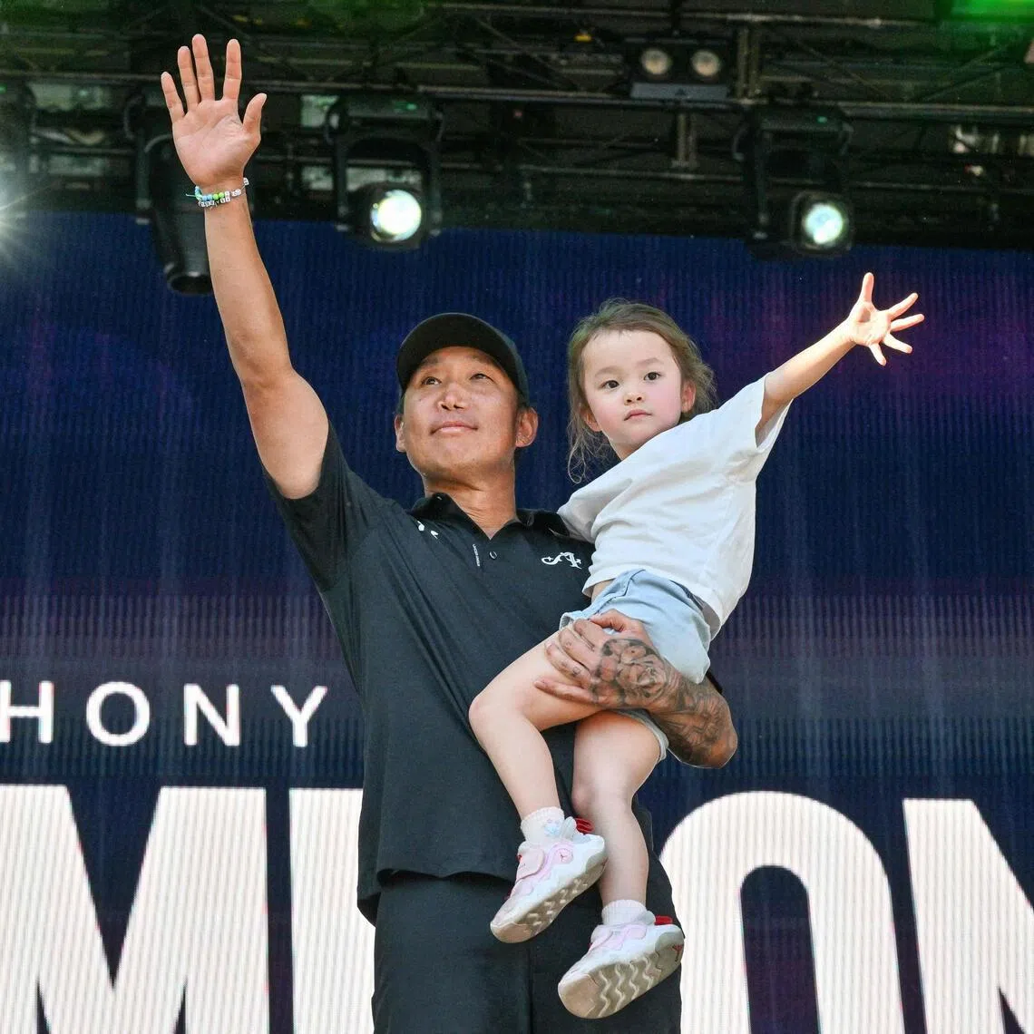 Anthony Kim, 40, celebrates on the podium with his daughter Isabella after he won a golf title for the first time in 5,795 days. 