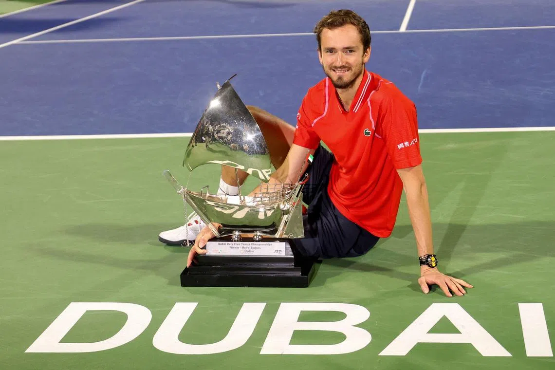 Russia's Daniil Medvedev poses with his trophy after winning against compatriot Andrey Rublev.