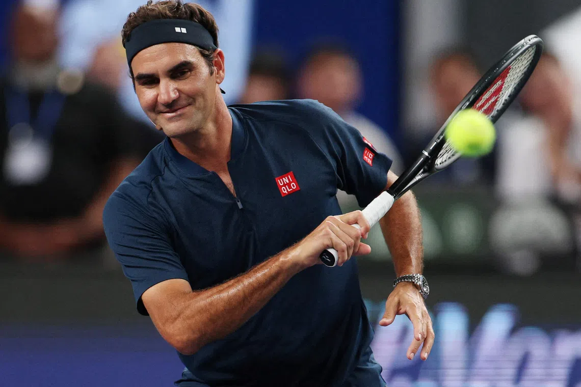 Tennis - ATP Masters 1000 - Shanghai Masters - Qizhong Forest Sports City Arena, Shanghai, China - October 10, 2025 Former tennis player Roger Federer in action with actor Donnie Yen during the celebrity doubles exhibition match against former tennis player Zheng Jie and actor Wu Lei. REUTERS/Go Nakamura
