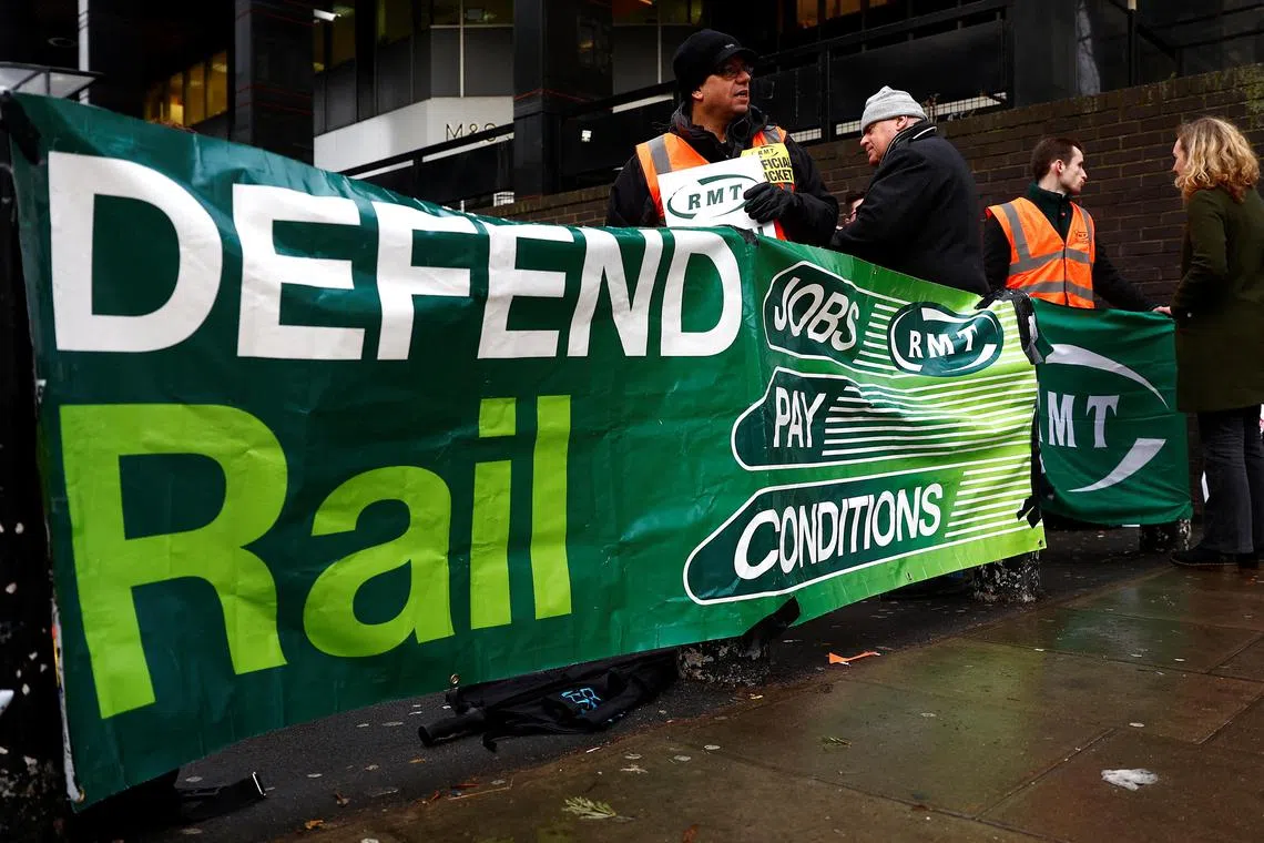 Members of the RMT union stand at a picket line at Euston station as rail workers continue a strike over pay and terms, in London, Britain, January 4, 2023.  REUTERS/Peter Nicholls