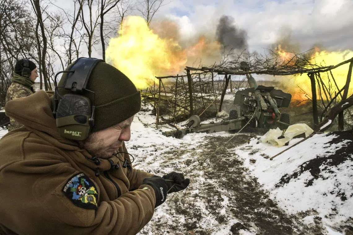 Soldiers with the Ukrainian armed forces fire a Howitzer at Russian positions in the Donbas region on Feb 14, 2023.