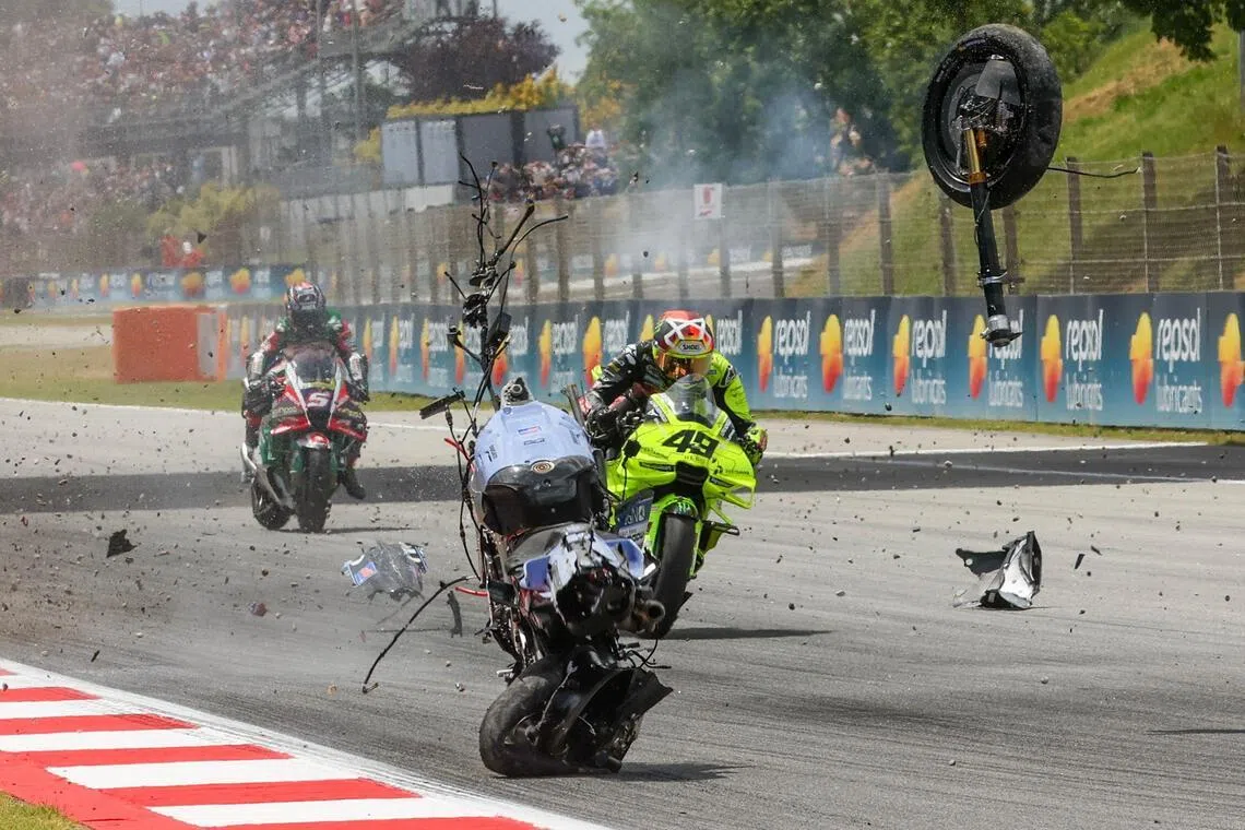 The motorcycle of Team Gresini Racing's Alex Marquez tumbles and breaks apart in front of Team VR46's Fabio di Giannantonio after Marquez crashed during the Catalunya Moto GP Grand Prix in Montmelo, near Barcelona, on May 17, 2026.