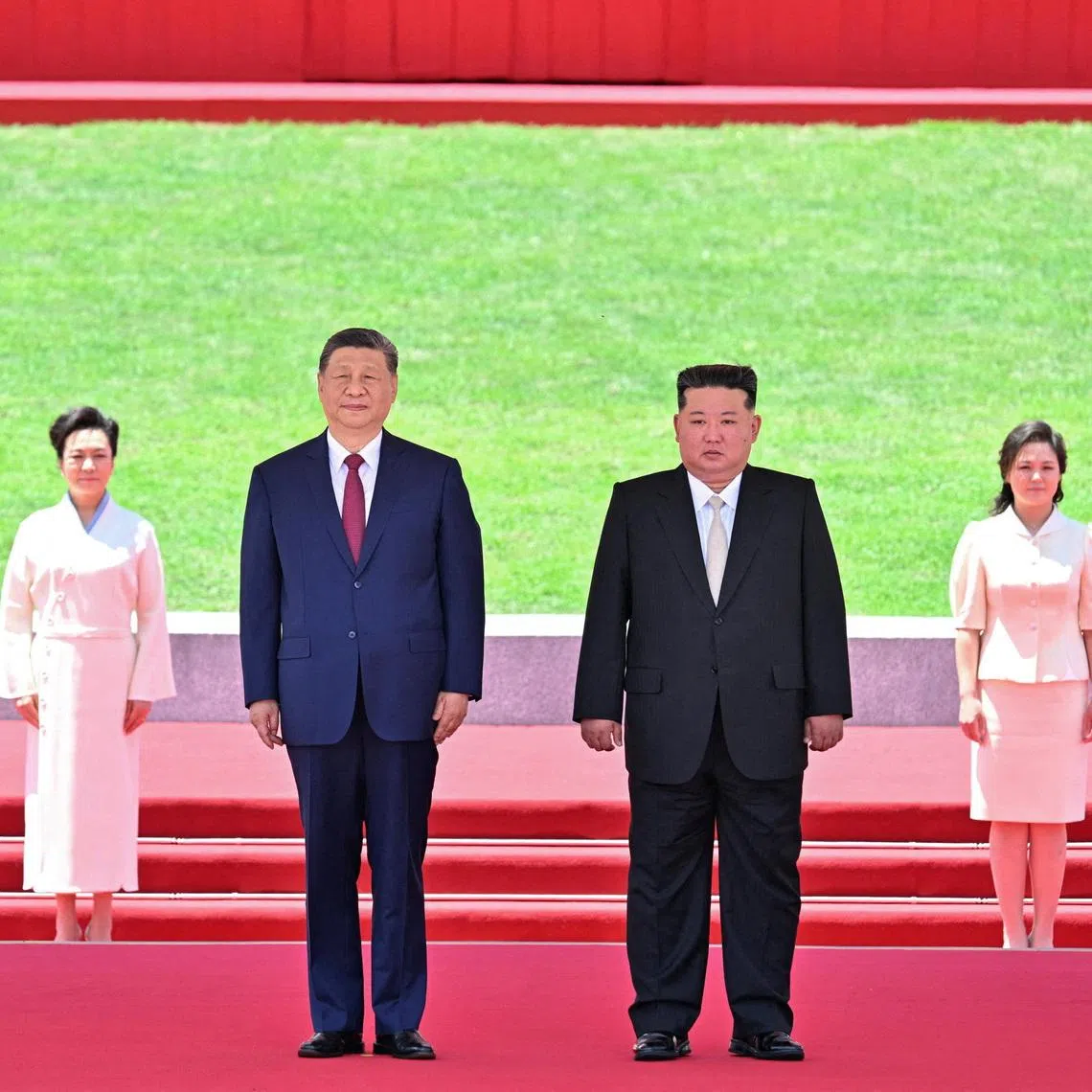 Chinese President Xi Jinping and North Korean leader Kim Jong Un watch a march-past as Kim holds a welcome ceremony for Xi at Kim Il Sung Square in Pyongyang, North Korea June 8, 2026. Yin Bogu/Xinhua via REUTERS