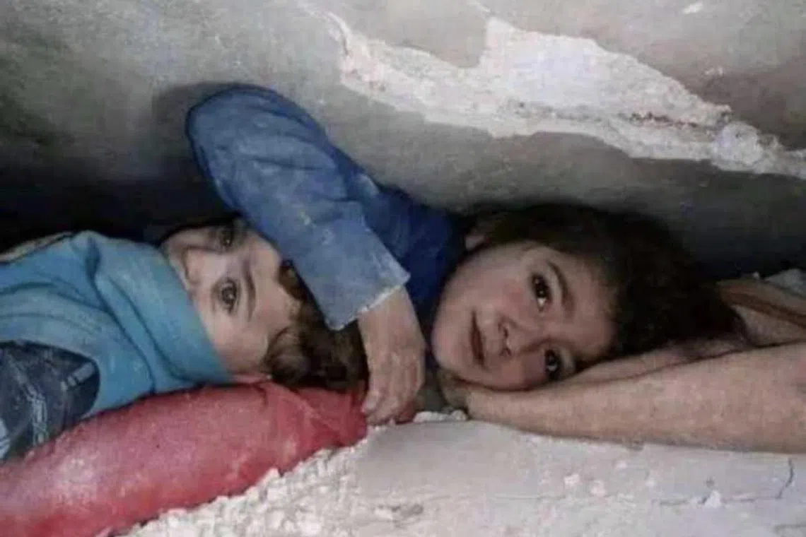 A 7-year-old Syrian girl was found cradling her younger brother while buried under debris.