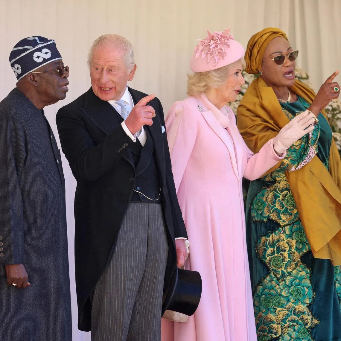 Nigerian President Bola Tinubu and first lady Oluremi Tinubu, Britain's King Charle and Queen Camilla on the dais in the Quadrangle at the inspection of the Guard of Honour during a ceremonial welcome at Windsor Castle on the first day of the president's state visit, on March 18, 2026 in Windsor, Britain. Chris Jackson/Pool via REUTERS