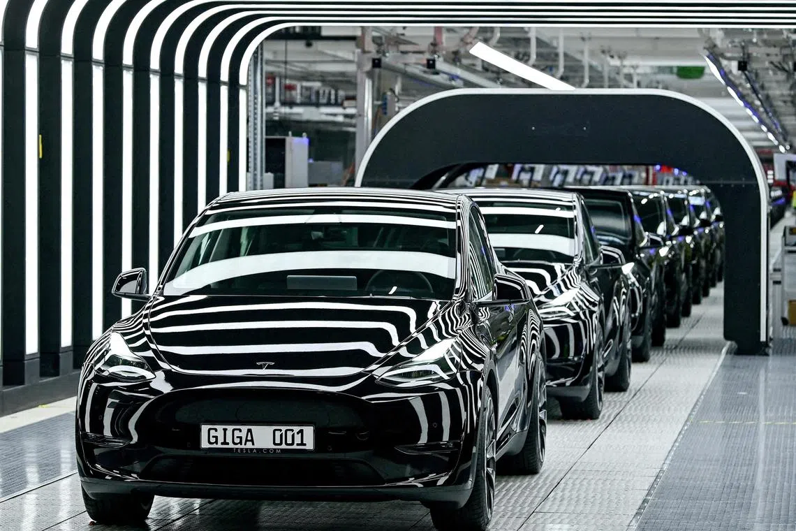 FILE PHOTO: Model Y cars are pictured during the opening ceremony of the new Tesla Gigafactory for electric cars in Gruenheide, Germany, March 22, 2022. Patrick Pleul/Pool via REUTERS/File Photo