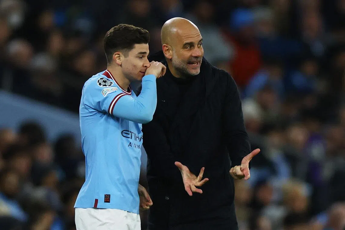 Manchester City manager Pep Guardiola with Julian Alvarez before he comes on as a substitute.