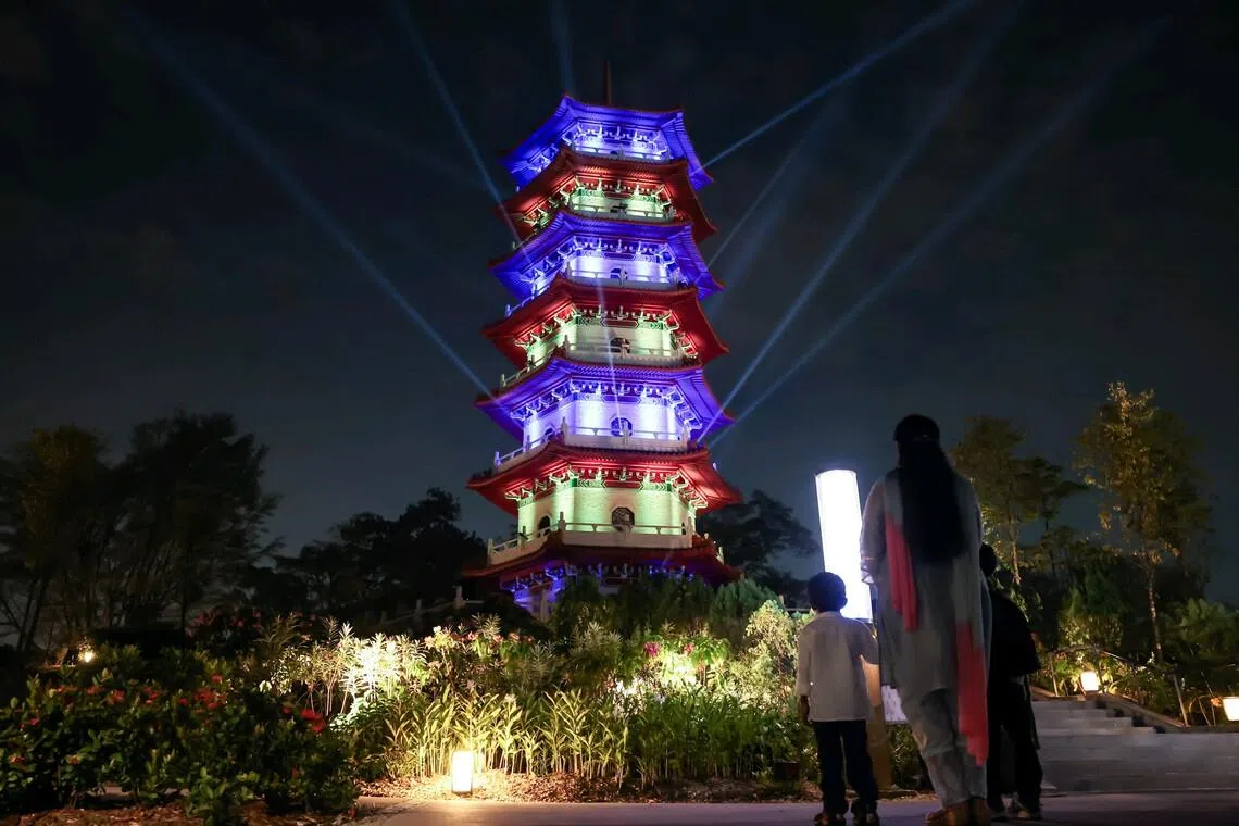The Cloud Pagoda at Chinese Garden transforms into a spectacular canvas of light at the Lights by the Lake festival in 2025.