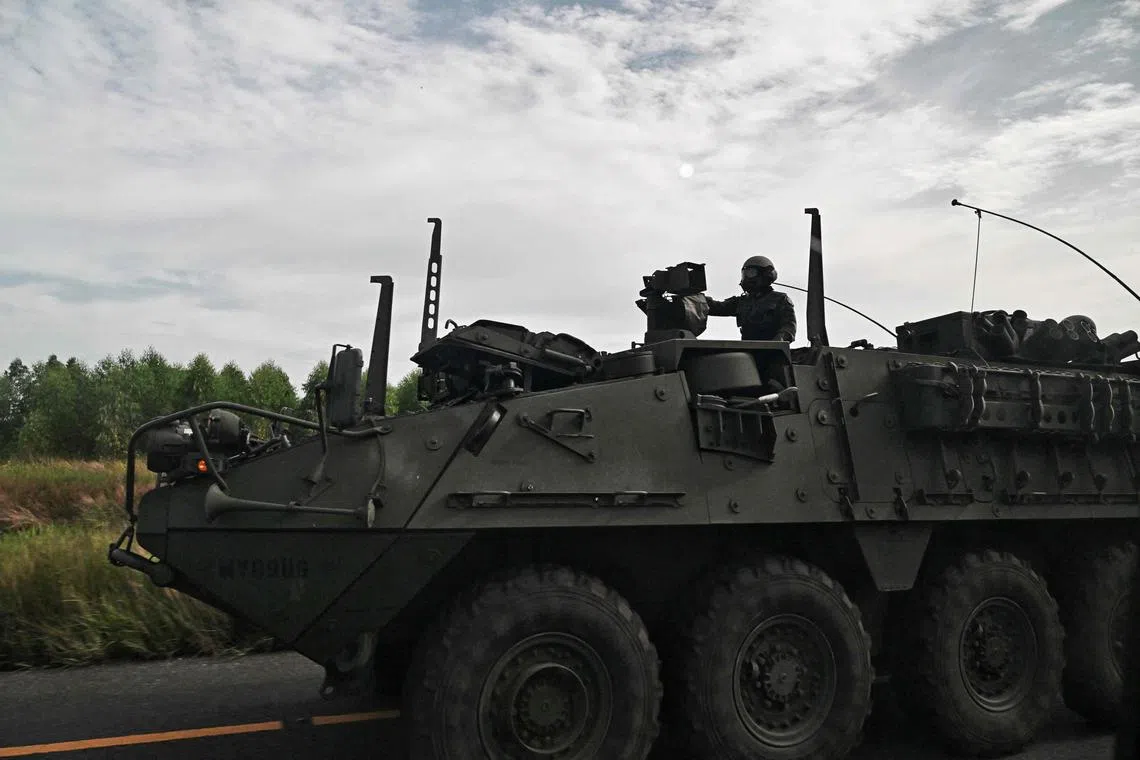 Royal Thai Army soldiers are pictured on an armoured vehicle in Chachoengsao province on July 24.