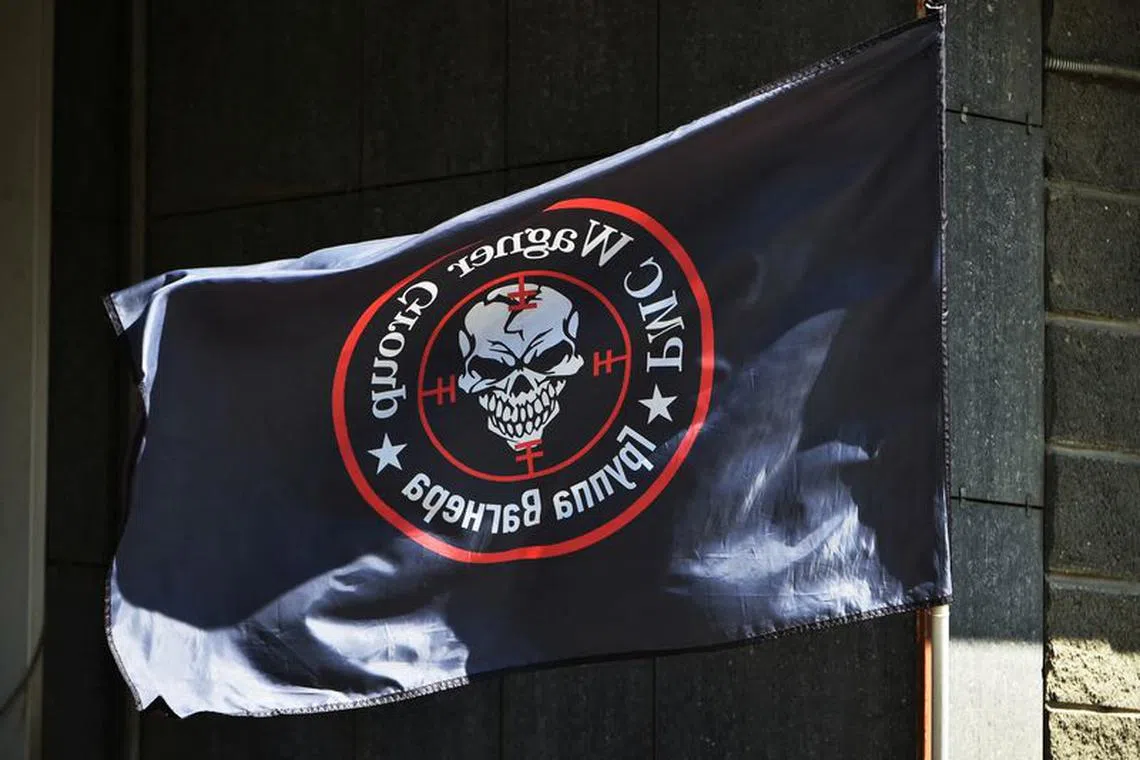 FILE PHOTO: A view shows a flag of the Wagner private mercenary group at a makeshift memorial with portraits of Russian mercenary chief Yevgeny Prigozhin and Wagner group commander Dmitry Utkin outside the local office of the Wagner private mercenary group in Novosibirsk, Russia August 24, 2023. REUTERS/Stringer