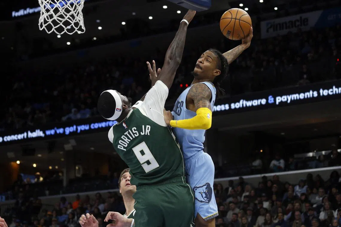 Memphis Grizzlies guard Ja Morant drives to the basket as Milwaukee Bucks forward Bobby Portis defends during the first half at FedExForum.