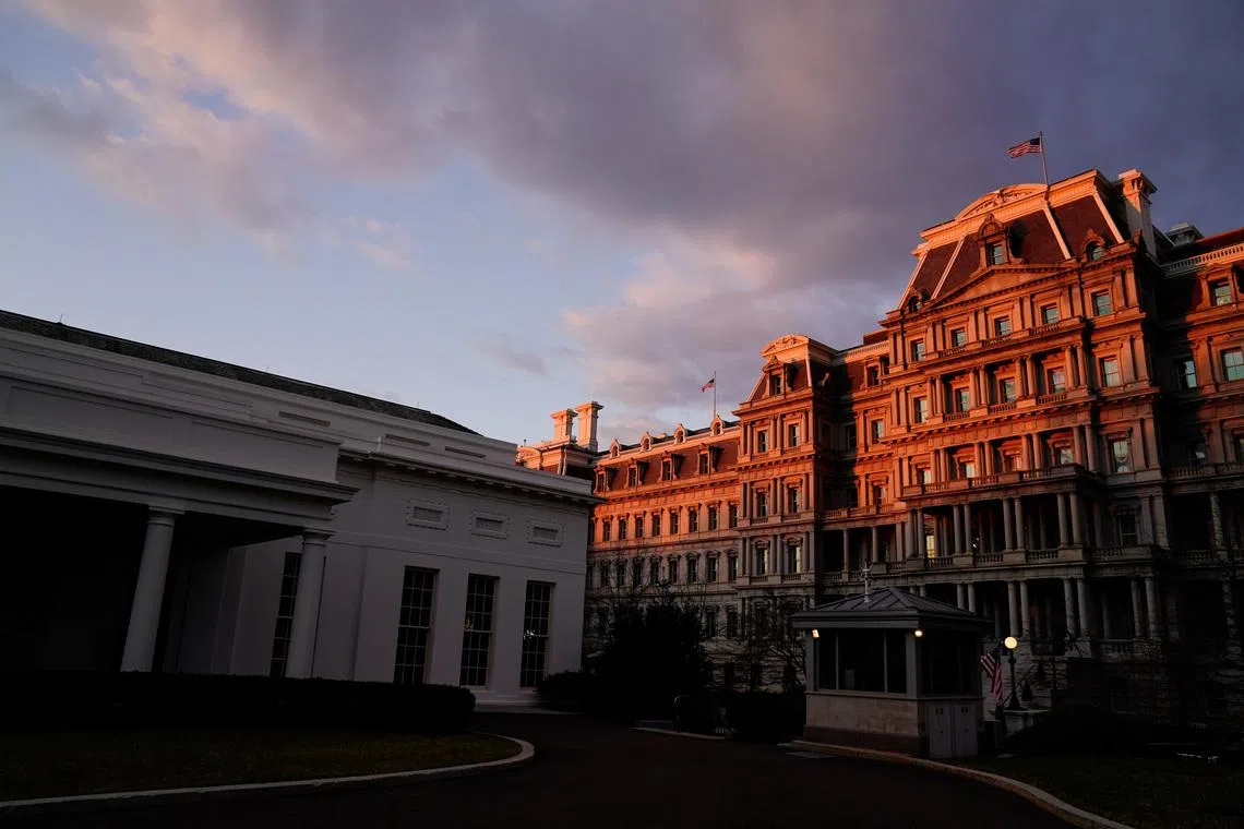 The West Wing of the White House and the Eisenhower Executive Office Building are seen at sunrise in Washington, U.S., January 23, 2021. REUTERS/Erin Scott
