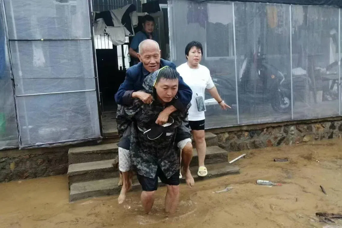 Officials evacuating trapped people on Aug 20 in Huludao, in China’s northeastern province of Liaoning.