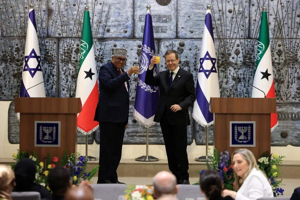 FILE PHOTO: Israel's President Isaac Herzog and Somaliland's President Abdirahman Mohamed Abdullahi hold up glasses of beverage before giving statements to the press at the President's Residence in Jerusalem, June 14, 2026. REUTERS/Ronen Zvulun/File Photo