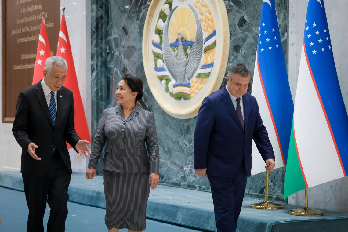 Senior Minister Lee Hsien Loong arrives at the Senate of the Oliy Majlis of Uzbekistan, the upper house of the country’s parliament, in Tashkent on Aug 31. He is received by Chairperson of the Senate Tanzila Narbayeva (centre) and Speaker of the Legislative Chamber Nuriddin Ismoilov (right).